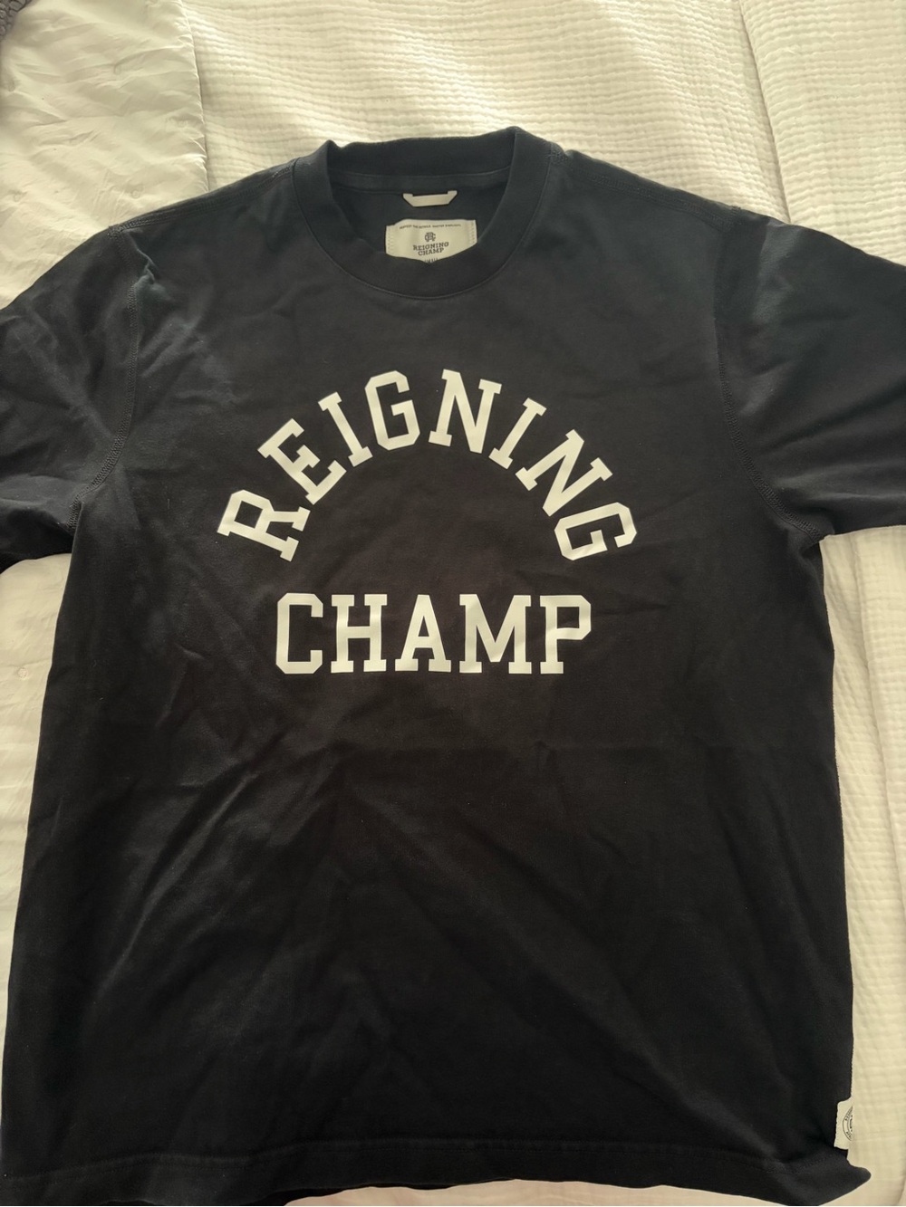 Reigning Champ Black Short Sleeve Logo Tee with White Arch Print.